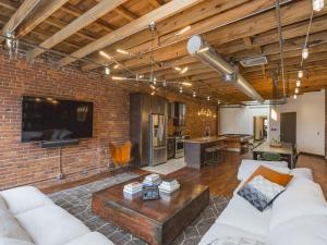 a living room with a brick wall at The Library-Downtown Nashville Luxury Penthouse Printers Alley Steps to Broadway in Nashville +55 photos