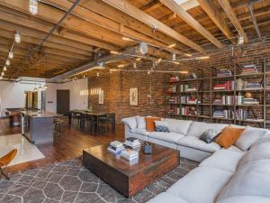 a living room with a couch and a table at The Library-Downtown Nashville Luxury Penthouse Printers Alley Steps to Broadway in Nashville