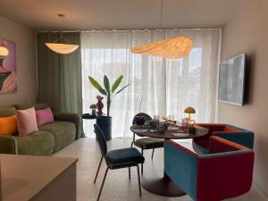 a living room with a couch and a table at Sunday Apartamenty SPA Miraż in Ustronie Morskie