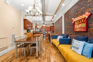 a dining room with a table and a brick wall at The Dolly Printer's Alley Nashville- 2 Blocks to Broadway in Nashville