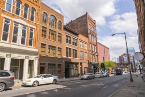 a city street with cars parked in front of buildings at The Dolly Printer's Alley Nashville- 2 Blocks to Broadway in Nashville