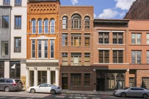 a brick building with cars parked in front of it at The Dolly Printer's Alley Nashville- 2 Blocks to Broadway in Nashville