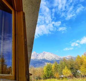 a window with a view of a mountain at Chata Biela Stopa in Tatranská Lomnica