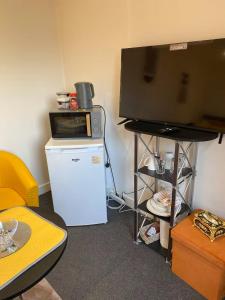 a room with a tv and a refrigerator and a tvicterictericter at Self-Contained Studio with Ensuite & Private Access in Hardwicke +6 photos