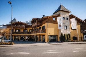 a large building on the side of a street at ALPENNEST - Balcony & Sauna Access in Seefeld in Tirol