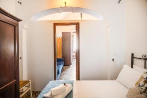 a room with a bed and a hallway with a mirror at Terrazza Anvi Mare & Relax in Polignano a Mare