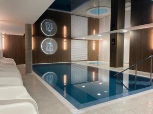 a large swimming pool in a hotel room at Sunday Apartamenty SPA Miraż in Ustronie Morskie