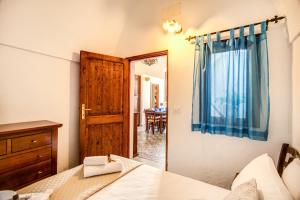 a bedroom with a bed and a wooden door at Terrazza Anvi Mare & Relax in Polignano a Mare