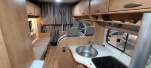 a bathroom in an rv with a sink at Camper Rental Elbasan in Elbasan