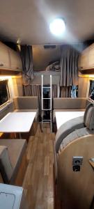 a small room with two beds and a table at Camper Rental Elbasan in Elbasan