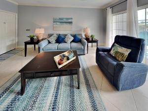 a living room with a couch and a coffee table at Dawn 315-saltwater Escape in Galveston