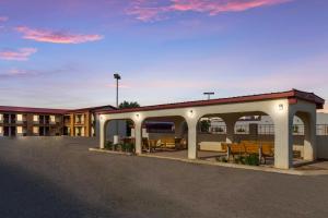 a parking lot of a hotel with a pavilion at Baymont by Wyndham Socorro in Socorro