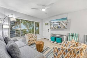 a living room with a couch and a tv at Sea Turtle Bungalow - 1136-2 in Siesta Key