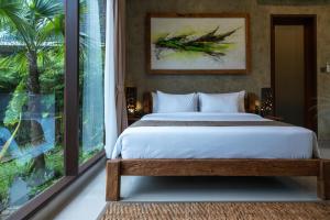 a bedroom with a bed and a large window at ElForest Villa Ubud, Payangan in Payangan +49 photos