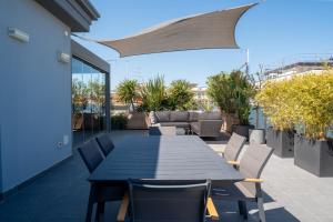 a blue table and chairs on a patio at Elegance Suite Apartments - Siroli Collection in Cervia
