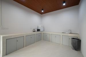 a kitchen with white cabinets and a counter top at Sea Vibes Pool Villa in Ban Bo So