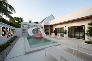 a house with a pool and a water slide at Sea Vibes Pool Villa in Ban Bo So