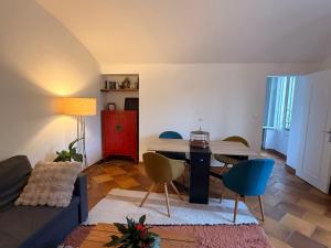 a living room with a couch and a table and chairs at Au bord de l eau in Villabé +14 photos