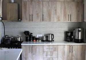 a kitchen with wooden cabinets and pots and pans at Noosh Ashnak guesthouse in Ashnak