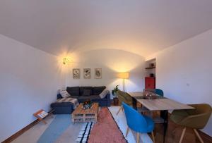 a living room with a blue couch and a table at Au bord de l eau in Villabé