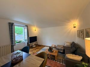a living room with a couch and a table at Au bord de l eau in Villabé