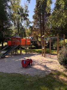 a playground with a red toy horse on the ground at Chalet in Le Tholy