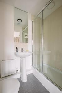 a bathroom with a sink and a shower at SmartSleep Apartments in Glasgow