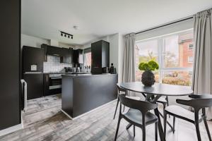 a kitchen and dining room with a table and chairs at SmartSleep Apartments in Glasgow