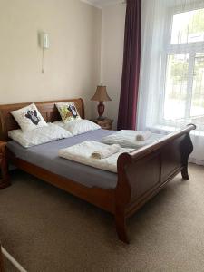 a large bed in a bedroom with a window at Hotel Koruna penzion in Teplice nad Metují