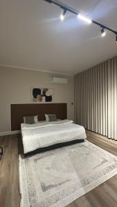 a bedroom with a large bed and a large rug at شقق مخدومة in Jazan