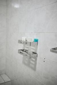 a bathroom with two white fixtures on a wall at Niyonest Guesthouse in Harare +11 photos