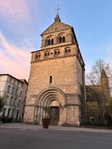 an old brick building with a clock tower at Pueblo Bonito Epinal avec Terrasse in Épinal