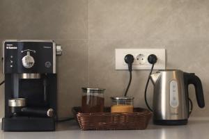 a coffeemaker and a coffee maker on a counter at LZR Apartments in Braşov