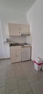 a small kitchen with a sink and a refrigerator at Smalis Studios in Lakkíon +12 photos
