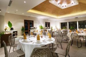 a banquet hall with tables and chairs with cakes on them at Bacau Bay Resort Coron in Coron