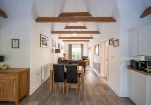 a kitchen and dining room with a table and chairs at Greenacres in Kelsale +18 photos