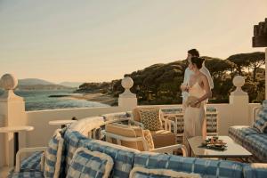 a bride and groom standing on the deck of a cruise ship at COMO Le Beauvallon - Golfe de Saint-Tropez in Grimaud