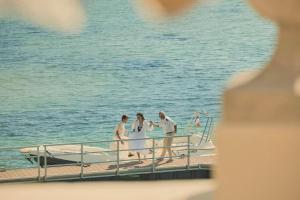 a group of three people on a boat on the water at COMO Le Beauvallon - Golfe de Saint-Tropez in Grimaud
