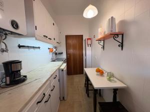 a kitchen with a counter and a table in it at Cabo de Sagres -1 bedroom apartment in Sagres