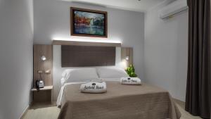 a bedroom with a bed with two pillows on it at Airfield Hotel & Spa in Vibo Valentia