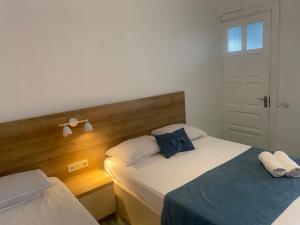 a bedroom with two beds with a blue bow tie at "Ламази"Домашняя гостиница in Kobuleti