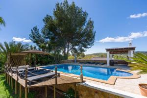 a pool with chairs and a gazebo at Asteria Eco Finca Sustainable 6 Bedroom Nature Retreat near UNVRS Ibiza in Santa Gertrudis de Fruitera +41 photos