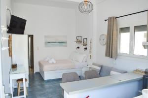 a living room with a bed and a couch at Giorgantis Studio II in Plaka Milou