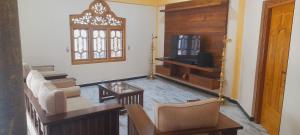 a living room with a couch and a tv at Europenvilla in Mannar +8 photos