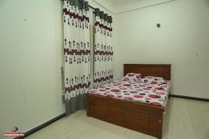 a bedroom with a bed with red and white sheets at Europenvilla in Mannar