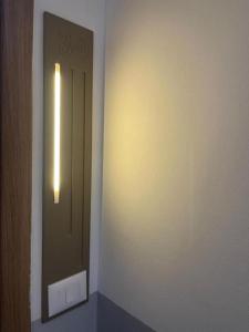 a hallway with a door with a light on it at Enea Apartments 9 in Tirana +2 photos