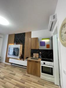 a kitchen with a stove and a clock on the wall at Enea Apartments 9 in Tirana