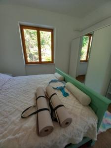 a bedroom with a bed with pillows and a mirror at Casa Vacanze Cael la Quiete in Riva di Solto