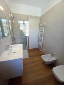 a bathroom with a white sink and a toilet at Casa Vacanze Cael la Quiete in Riva di Solto +32 photos