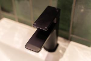a cell phone sitting on top of a bathroom sink at Base Dingle in Dingle